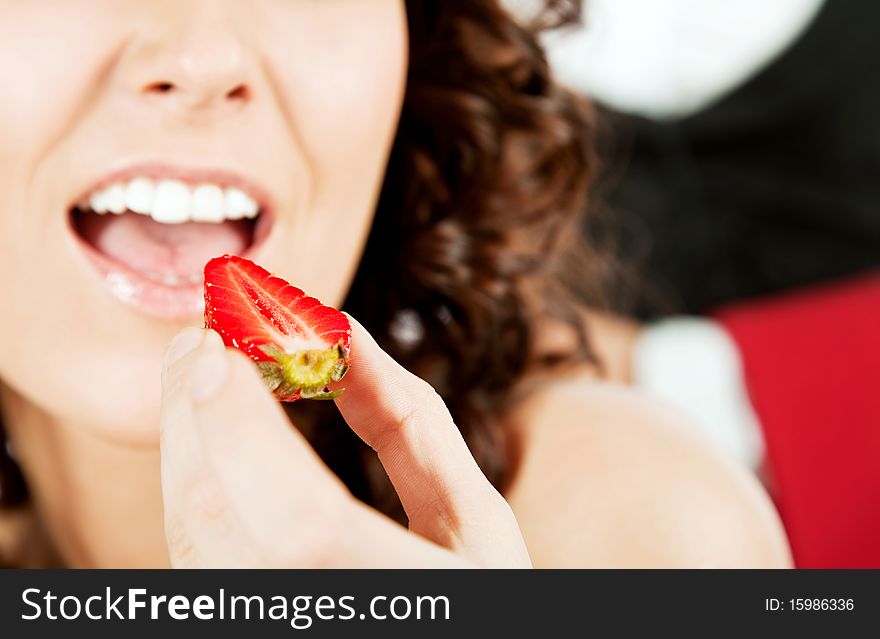 Woman eating strawberry