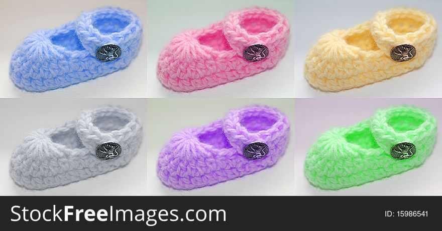 Six different colored baby booties with metallic lion button.