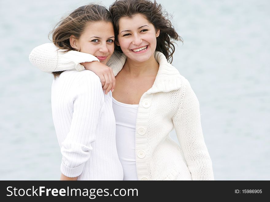 Two young happy girls on natural background. Two young happy girls on natural background