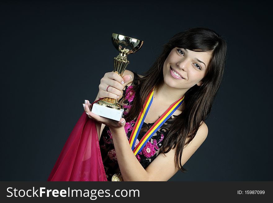 Teen showing golden cup