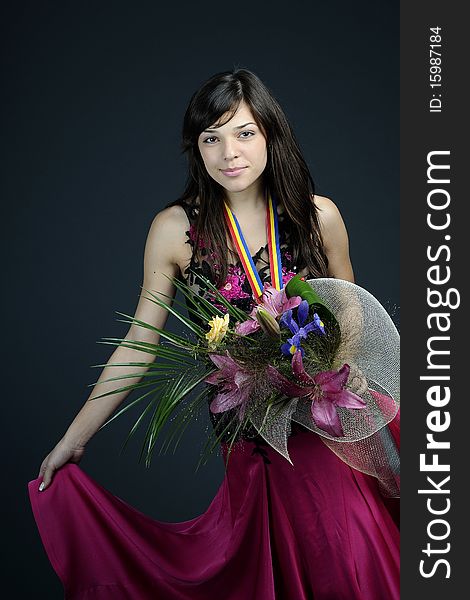 Young woman winning competition and posing with flowers and medal. Young woman winning competition and posing with flowers and medal