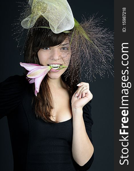 Elegant teenager girl posing with flower and hat. Elegant teenager girl posing with flower and hat