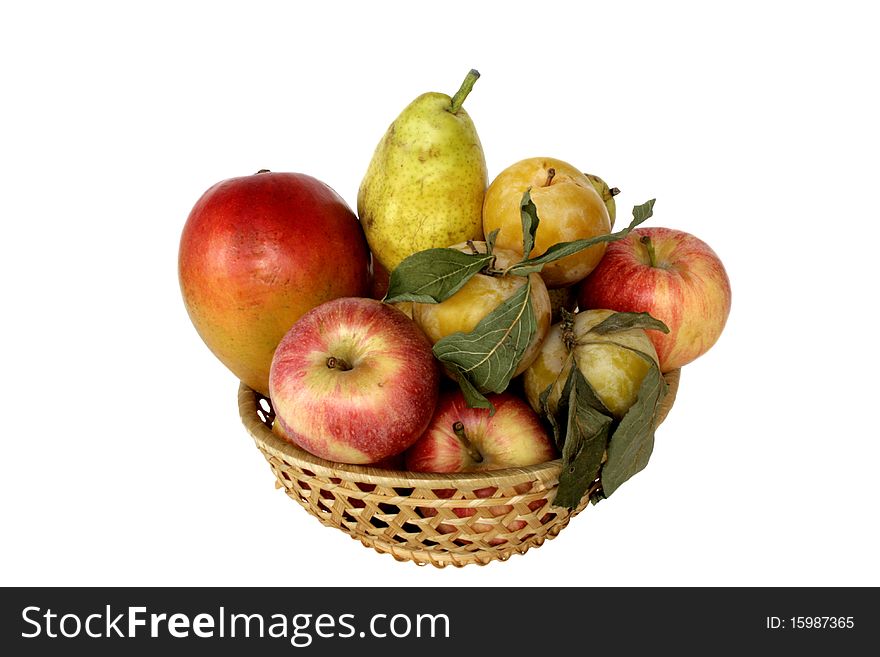 Fruit in wicker wooden vase in isolated over white. Fruit in wicker wooden vase in isolated over white
