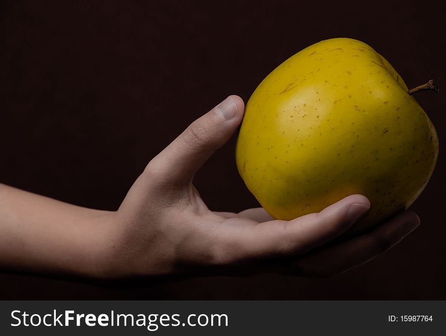 Hand that gives a fresh apple. Concept of healthy life style. Hand that gives a fresh apple. Concept of healthy life style.