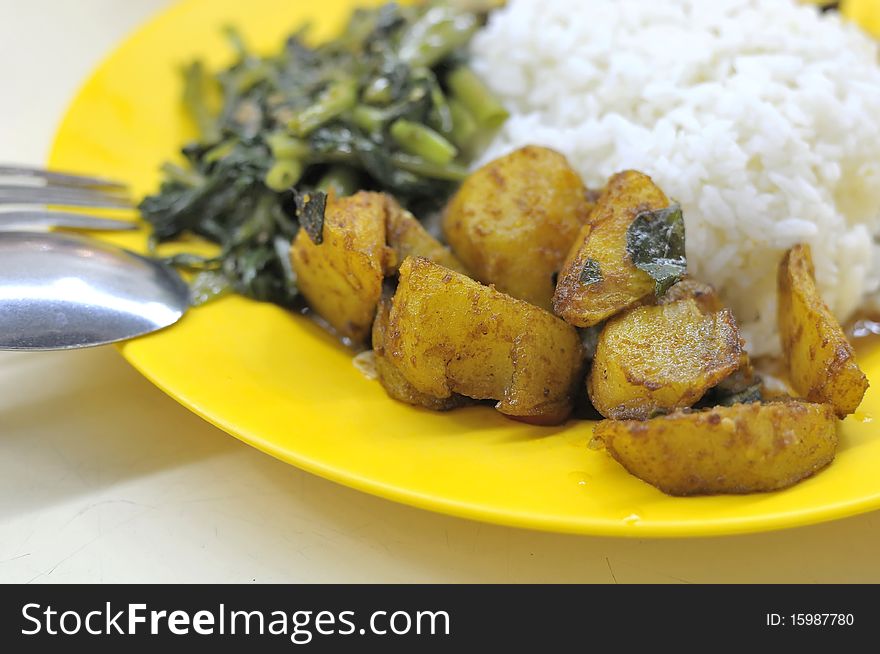 Rice set meal with vegetables and fried potatoes. Suitable for concepts such as diet and nutrition, healthy lifestyle, and food and beverage.