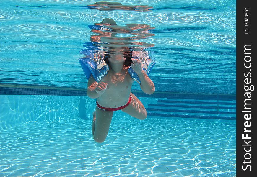 Swimming underwater photo of a child