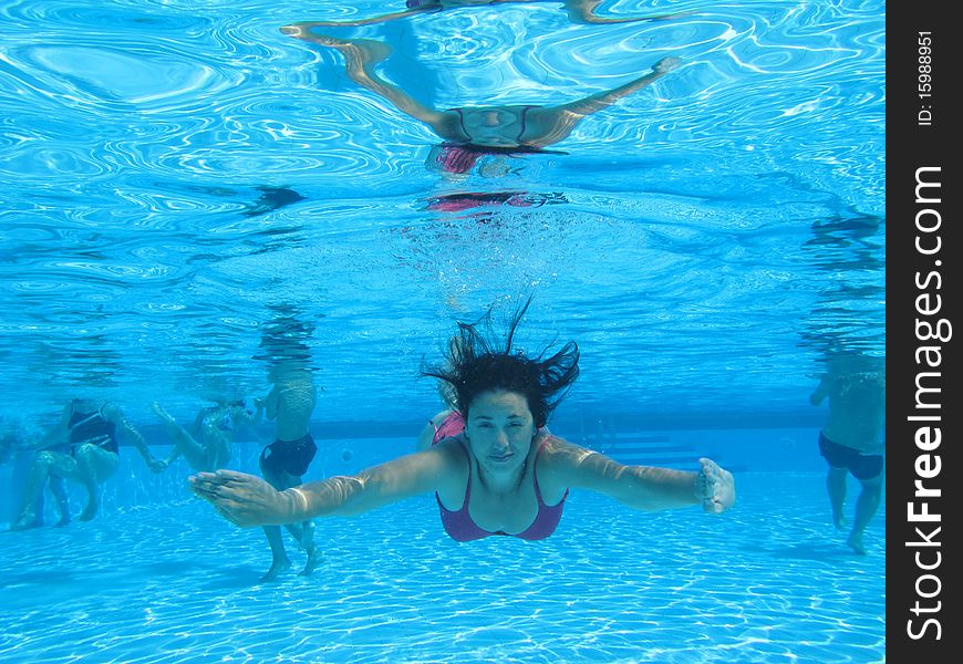 Woman swimming on a pool, underwater photo. Woman swimming on a pool, underwater photo