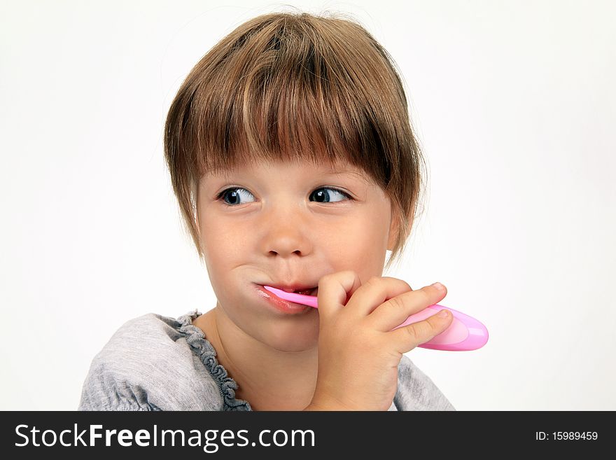 The smiling girl brushes teeth on a white background