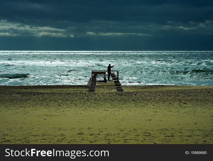 A man fishing on the Atlantic Ocean. A man fishing on the Atlantic Ocean