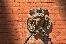 Lion Face Gargoyle With Chain On Brick Wall Stock Image