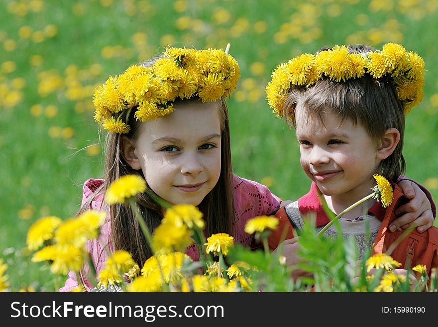 Brother and sister with dandelion garlands