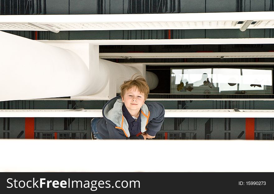 Child enjoys using the moving staircase, birds view