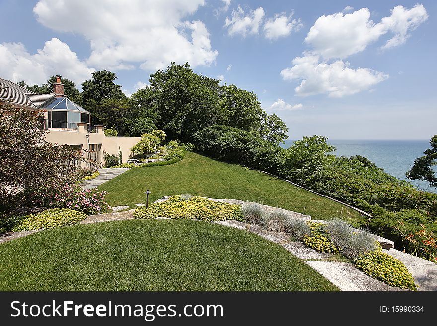 Rear view of luxury home with lake view