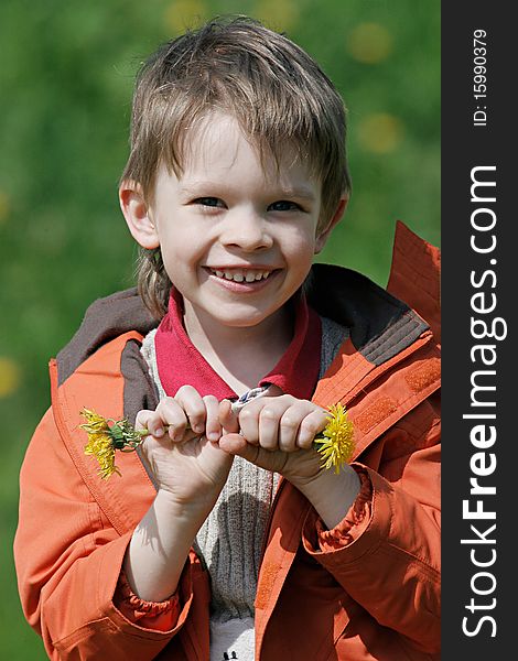 Young boy enjoy summer time in the dandelion meadow. Young boy enjoy summer time in the dandelion meadow.