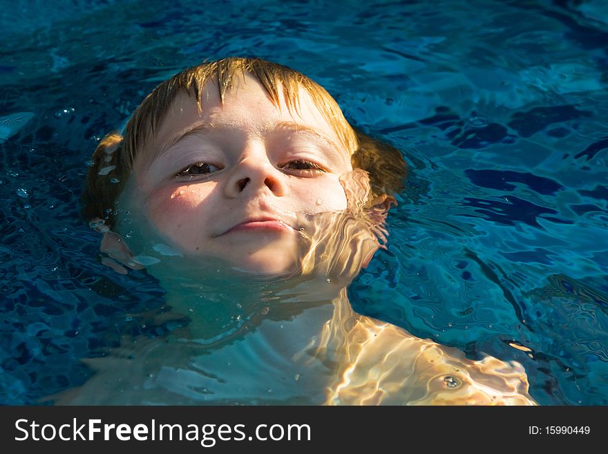 Child enjoys swimming in the pool