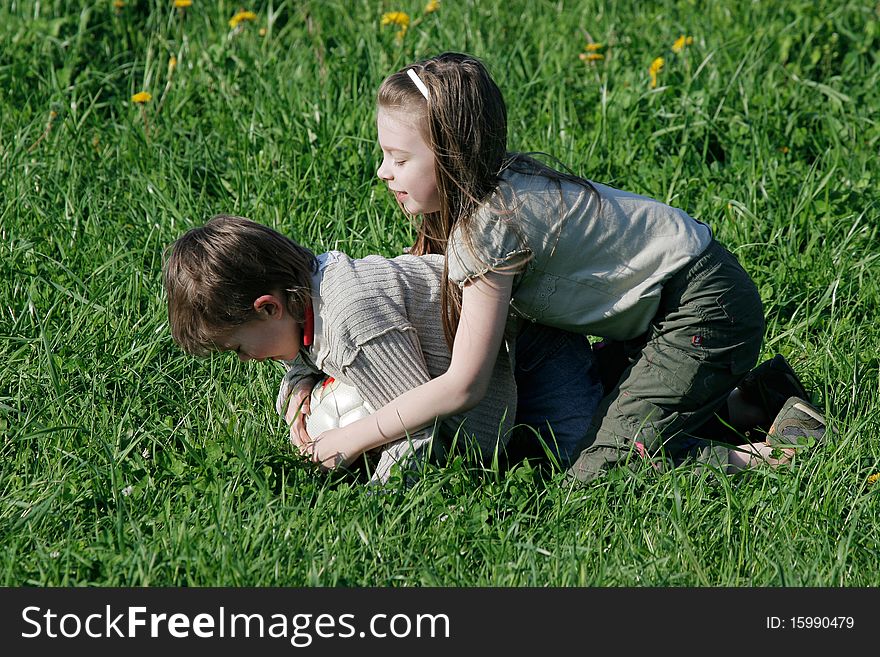 Brother and sister enjoy summer time in the green grass. Brother and sister enjoy summer time in the green grass.