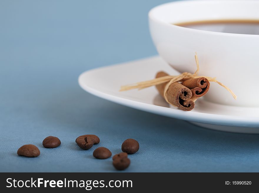 Coffee beans and cup of coffee with cinnamon. Coffee beans and cup of coffee with cinnamon