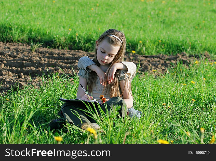 Brother and sister enjoy summer time in the green grass. Brother and sister enjoy summer time in the green grass.