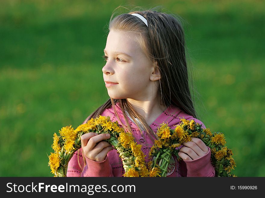 Nice, young girl enjoy summer time in the dandelion meadow. Nice, young girl enjoy summer time in the dandelion meadow.