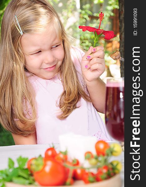 Girl with flower in hand, refusing food. Girl with flower in hand, refusing food