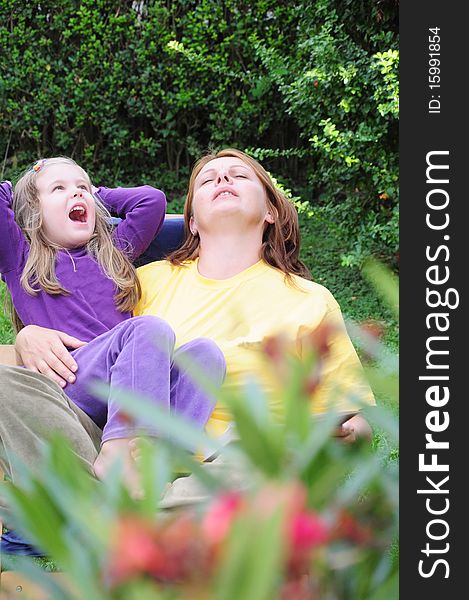 Mother and daughter have fun in the yard. Mother and daughter have fun in the yard