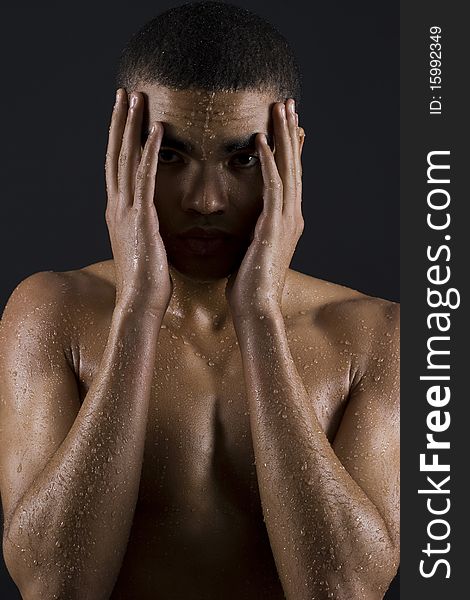 Drops of the water on naked body of a young man on black background. Drops of the water on naked body of a young man on black background.