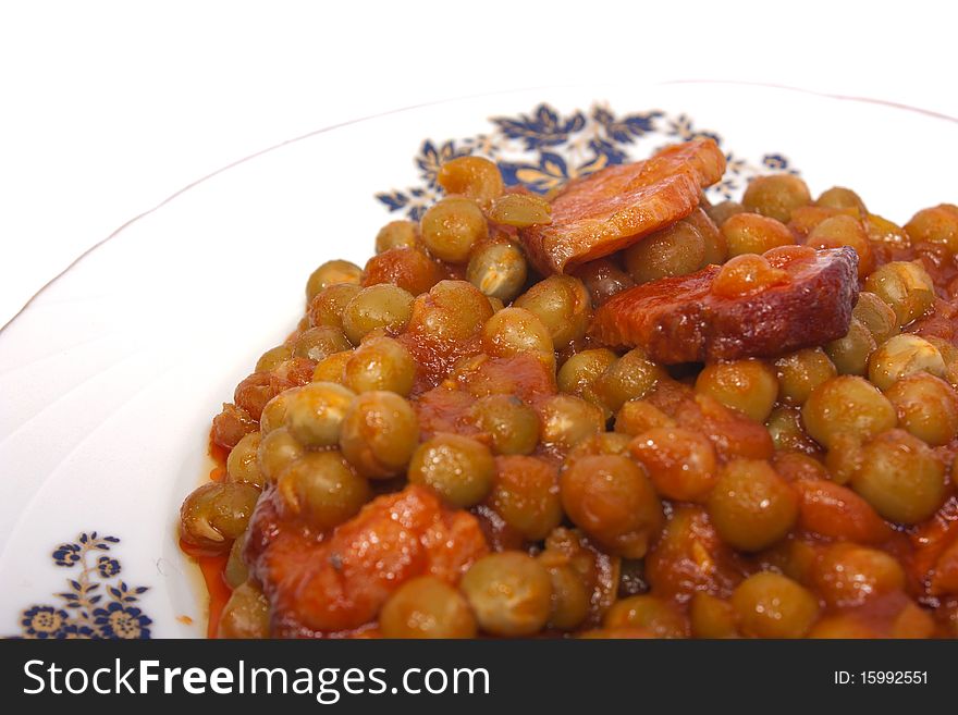 Cooked peas with bacon and carrots isolated on white background with clipping path. Cooked peas with bacon and carrots isolated on white background with clipping path