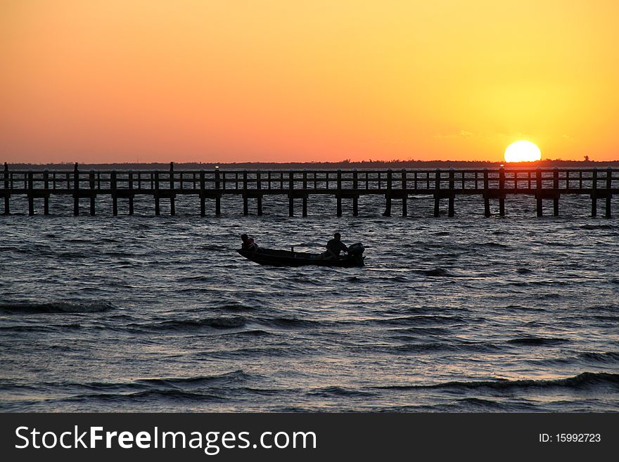 Colorful sunset over Charlotte Harbor,Florida, man in boat fishing. Colorful sunset over Charlotte Harbor,Florida, man in boat fishing.
