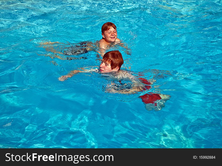 Two brothers having fun in the pool. Two brothers having fun in the pool