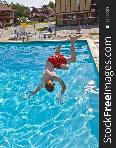 Child has fun jumping in the pool. Child has fun jumping in the pool