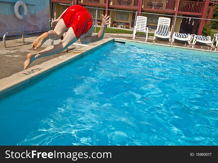 Child has fun jumping in the pool. Child has fun jumping in the pool