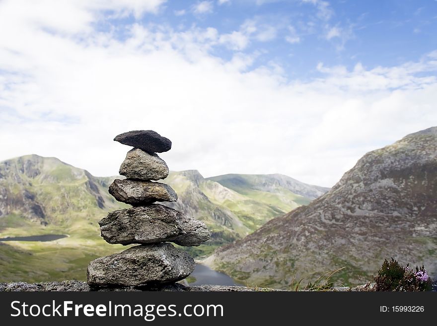 Tower of stones in mountains background