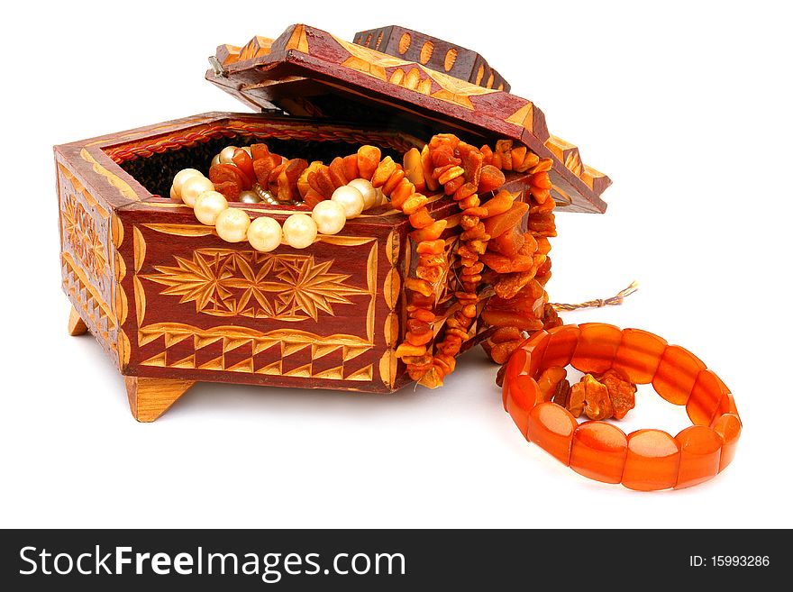 The wooden casket and amber isolated on white background