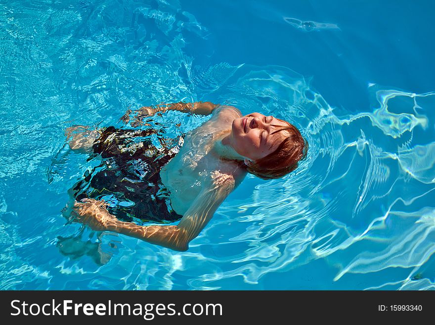 Child has fun swimming in the pool. Child has fun swimming in the pool