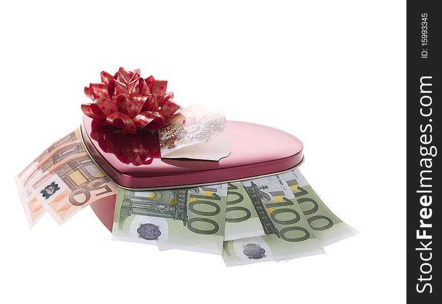 The photo shows some banknotes and a container in form of a heart over white