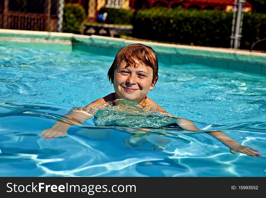 Child has fun swimming in the pool. Child has fun swimming in the pool