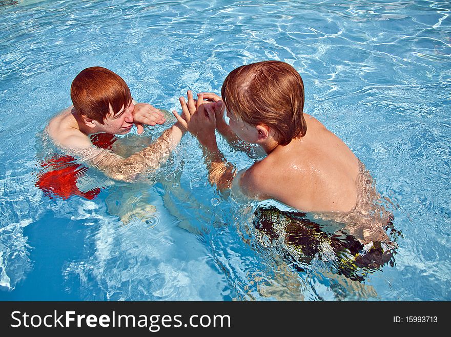 Brothers have fun in the pool. Brothers have fun in the pool
