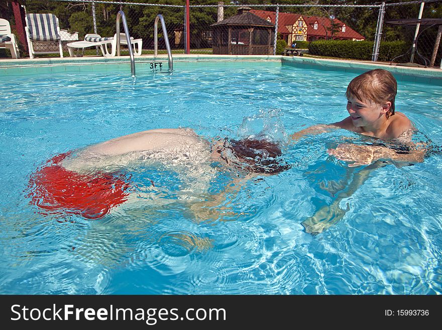 Brothers have fun in the pool. Brothers have fun in the pool