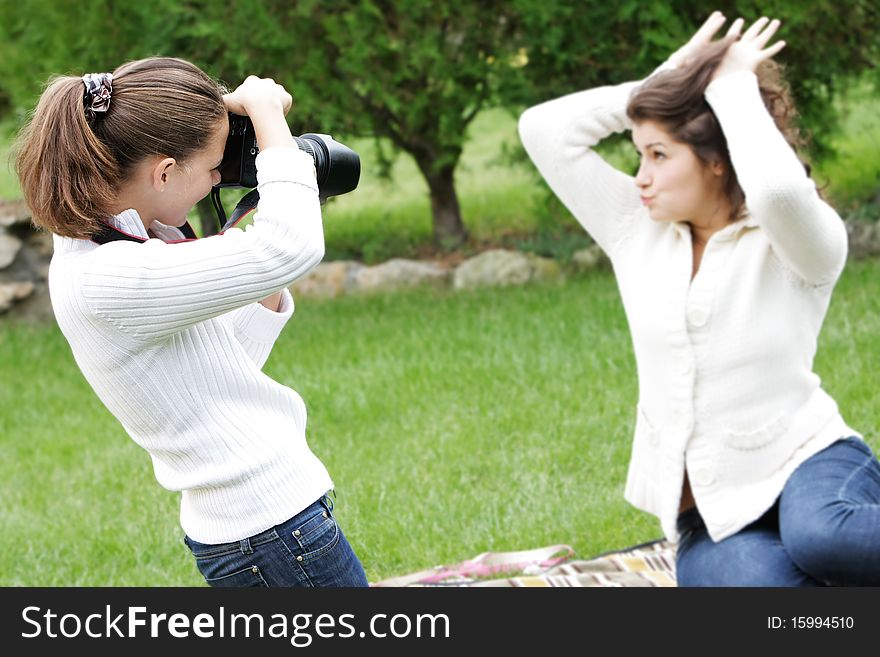 Two girls taking pictures on nature