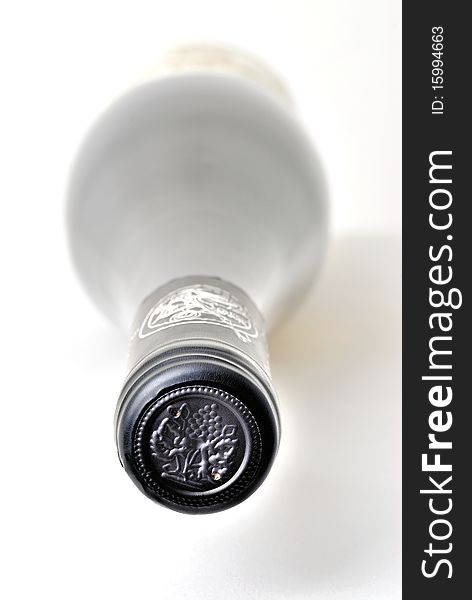 Lateral positioned bottle of wine on white background