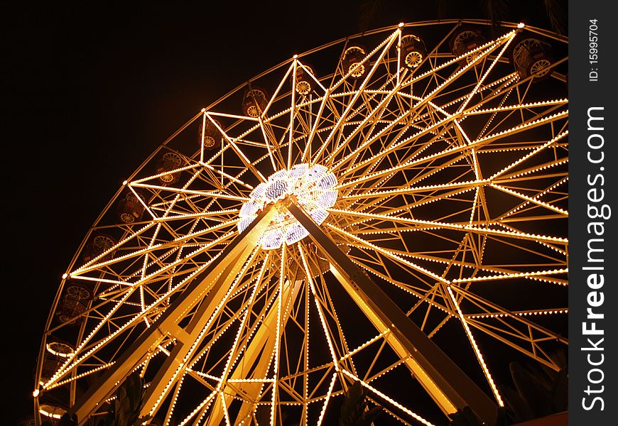 A giant Ferris Wheel lights up the night.