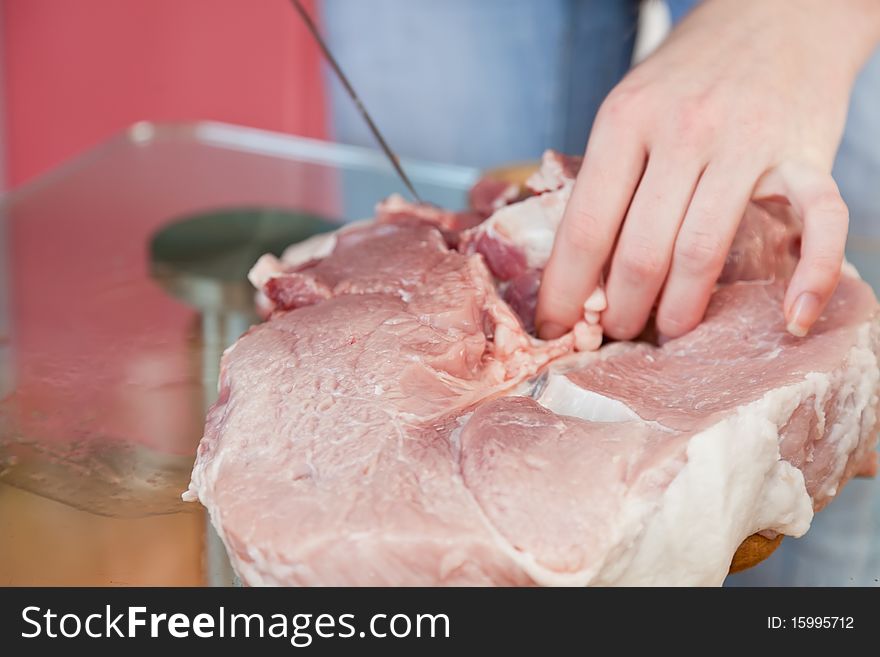 Man is cut fresh pork meat. Man is cut fresh pork meat