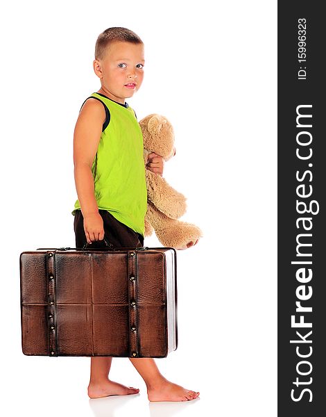 A barefoot preschool boy ready for an overnight away from home.  Isolated on white. A barefoot preschool boy ready for an overnight away from home.  Isolated on white.