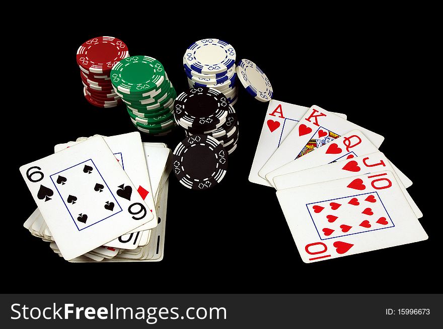 Royal Flush Card Hand with Poker Chips Isolated on black. Royal Flush Card Hand with Poker Chips Isolated on black