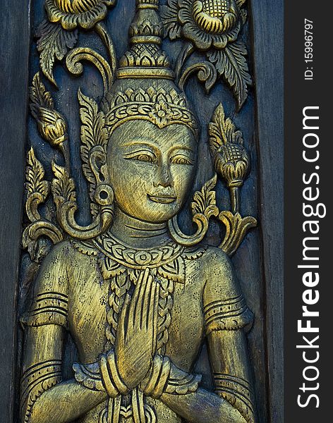 Buddha carved gold paint on thai church door