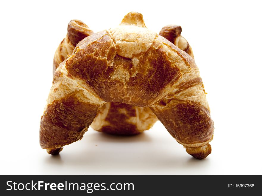 Brown baked croissants onto white background
