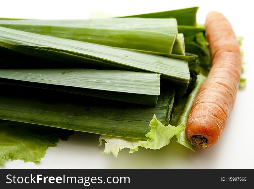 Leek with carrot on salad leaf