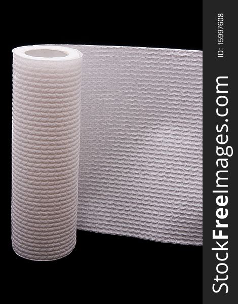 A white paper towel roll against a black background