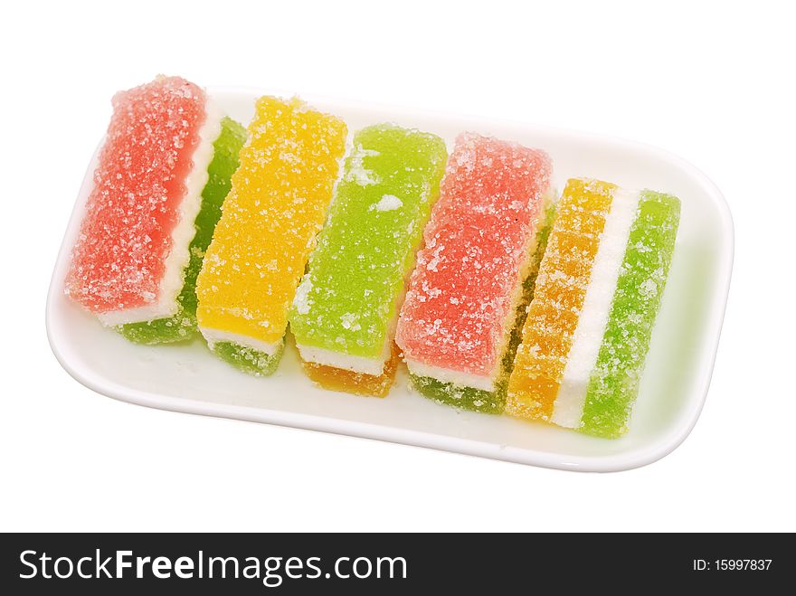 Fruit candy slices on plate isolated. Fruit candy slices on plate isolated