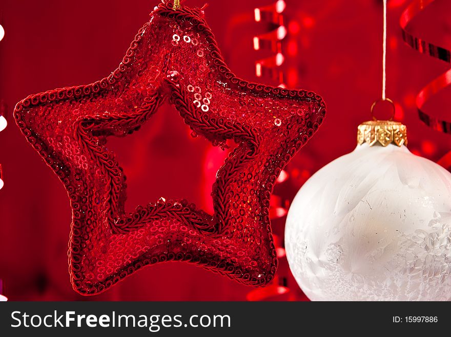 Beautiful christmas star and white baubles on red background